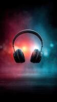 Colorful headphones suspended in mid-air with vibrant blue and red background lighting in a creative design setup photo