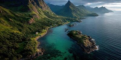 Breathtaking coastal landscape showcasing rugged mountains and clear turquoise waters at sunrise in a remote location photo
