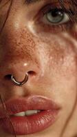 Close-up of a person with distinctive freckles and a nose ring in natural light photo