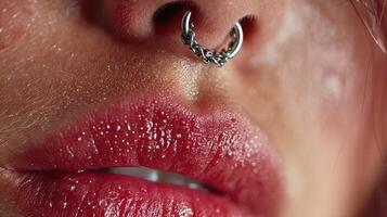 Close-up view of glistening lips with a unique nose ring in artistic lighting photo