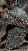 Detailed close-up of a vintage warrior helmet showcasing ornate carvings and unusual patina photo