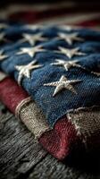 Close-up of a folded American flag showcasing intricate stitching on a rustic wooden surface photo