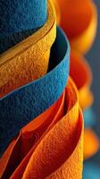 Creative display of colorful felt rolls in vibrant blue and orange hues illuminated in a studio setting photo