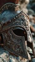 Ancient warrior helmet resting among stones at sunset, showcasing intricate designs and aged patina photo