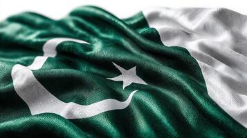 Vibrant Pakistani flag waving under bright sunlight, showcasing deep green fabric with white crescent and star emblem photo