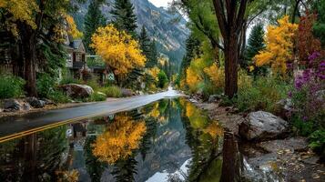 Beautiful autumn landscape with vibrant trees and reflections in puddles along a serene mountain road photo
