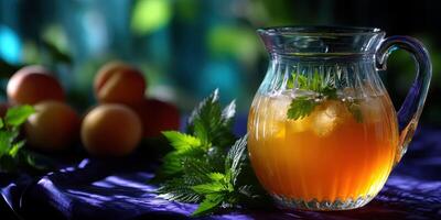 Refreshing herbal drink served in a glass pitcher with fresh mint and ripe apricots on a purple fabric background photo