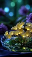 Brightly glowing yellow flowers arranged in a glass dish on a dark background with purple blooms in the backdrop photo