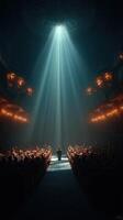 Spotlight shines on speaker in an empty theater during evening performance photo