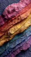 Vibrant layers of textured colors form an artistic display resembling natural stone formations illuminated by soft light photo