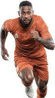 Player in action during a soccer match wearing orange uniform on a pristine field in bright sunlight photo