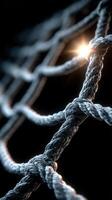 Detailed close-up of intertwining ropes with soft light highlighting the texture and structure in a dark setting photo
