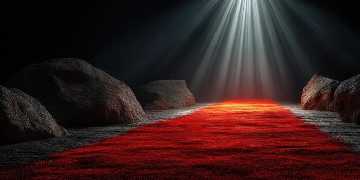 Illuminated red carpet leading through rocky terrain in a dark environment with beams of light piercing through photo