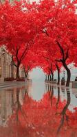 Vibrant red trees line tranquil pathway beside calm water in autumn setting at city park photo