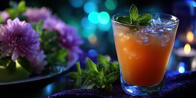 Refreshing beverage with ice and mint displayed beside colorful flowers on a stylish table in soft lighting at evening gathering photo