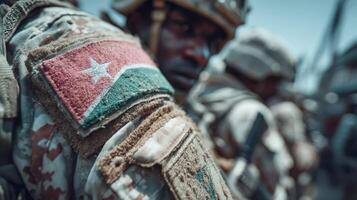 Soldiers in tactical gear display pride in their nation during a training exercise in South Sudan's harsh landscape photo