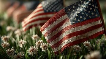Small American flags displayed among flowers at a memorial service honoring veterans in a serene garden setting photo
