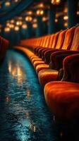 Illuminated red velvet seats in a vintage theater during a quiet evening performance photo