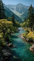 Serene river flowing through lush green forest with majestic mountains in the background on a clear sunny day photo