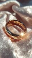Elegant gold ring shining on soft silk fabric in natural light photo