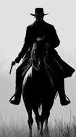 Cowboy silhouette rides through tall grass at dawn with revolver drawn photo