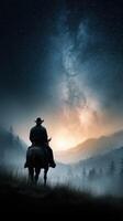 Stunning silhouette of a cowboy riding in the mountains under a starry sky at dawn photo
