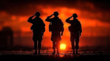 Soldiers salute at sunset, honoring service and sacrifice in a moment of reflection and unity photo