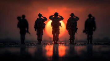 Silhouettes of soldiers saluting at sunset during a military ceremony near a base photo
