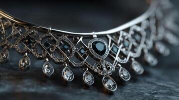 Exquisite silver necklace with intricate design and sparkling gems displayed on a dark stone surface photo
