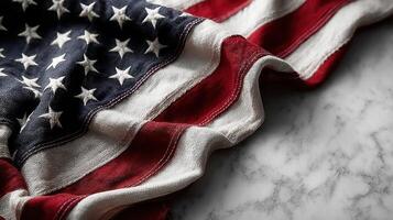 Waving American flag draped elegantly on a textured marble surface during a patriotic celebration photo