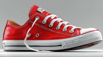 Red sneaker displayed on a gray background highlighting its design and color variations photo