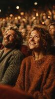 Couple enjoying performance in a warm theater atmosphere during an evening show with audience in the background photo