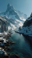 Majestic snow-covered mountains rise above a tranquil river in a serene winter landscape at dawn photo