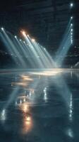 Dramatic lighting illuminates an empty ice rink in a sports arena during a winter evening photo