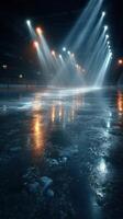 Ice rink illuminated with dramatic lighting in an empty arena during evening hours photo