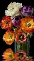 Colorful bouquet of ranunculus flowers in a glass vase reflecting on water surface photo