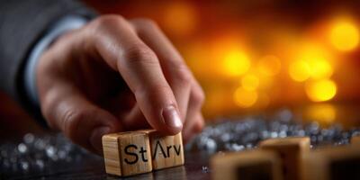 Hand arranging wooden blocks with letters in a warm, illuminated setting during a creative workshop photo