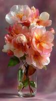 Beautiful bouquet of peonies arranged in a clear glass vase on a soft gradient backdrop in warm tones photo