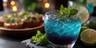 Refreshing blue cocktail with mint and lime served at an evening gathering photo
