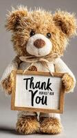 Adorable teddy bear holding a sign expressing gratitude with a warm and inviting appearance, perfect for celebrations or gifts photo