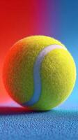 Bright yellow tennis ball resting on a blue surface with vibrant background colors photo