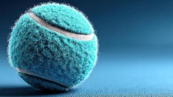 Bright blue tennis ball on a smooth surface highlighting vibrant color and unique texture in a serene setting photo