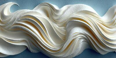 Swirling cream texture displayed against a smooth blue background creating an artistic food design photo