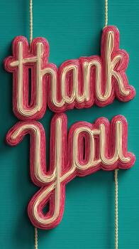 Bright thank you message displayed with colorful lettering on a textured turquoise background photo