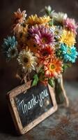 Bright and colorful bouquet of flowers with a thank you sign in a rustic setting photo