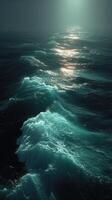Waves gently breaking against the dimly lit ocean surface under a mysterious sky at twilight photo