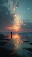 Stunning sunset at the beach with a lone figure reflecting on the water's surface under a starry sky photo