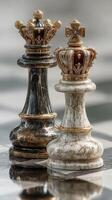Intricately designed chess pieces featuring a black and gold king alongside a white and gold king on a polished surface photo