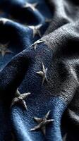 Close-up view of a textured American flag fabric displaying embroidered stars on a dark blue background photo