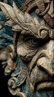 Intricate wooden sculpture of a fierce deity with detailed features and expressive eyes captured in atmospheric light photo